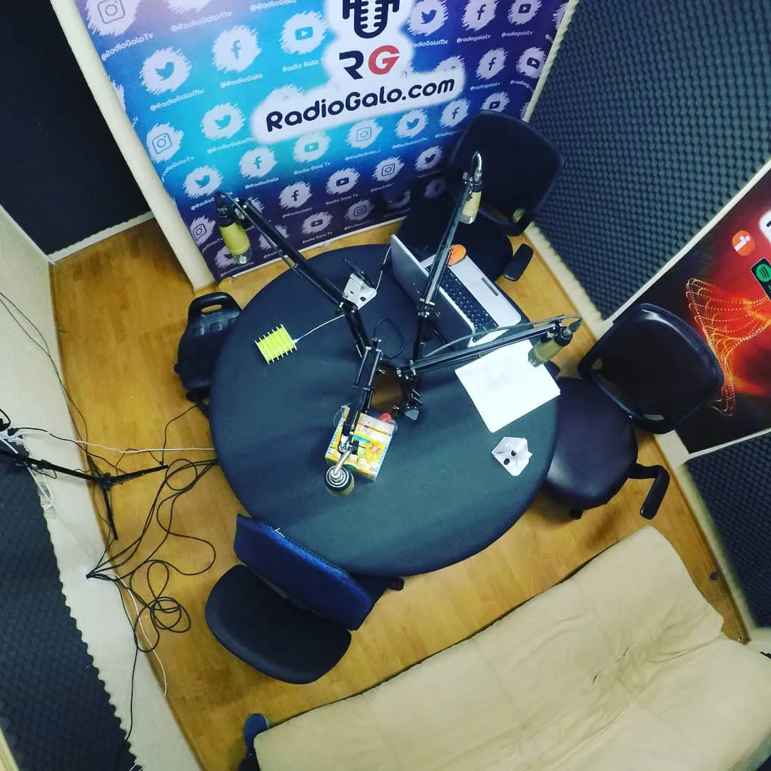 La cabina vista desde arriba: mesa redonda, cuatro micrófonos y sillas